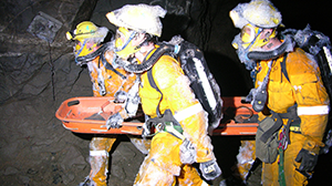 mines rescue case study - rescue team carries stretcher with patient