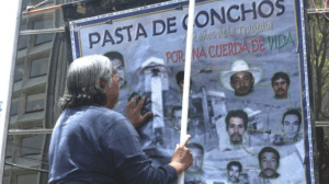 Family members hang a poster to remember Pasta de conchos mine workers killed in gas explosion