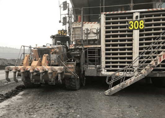 A grader and truck collide