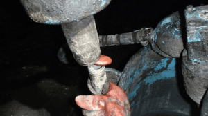 mineworker's thumb was lacerated by a grouting pump